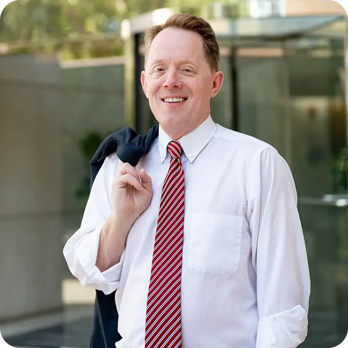 there is a man wearing a tie and a white shirt