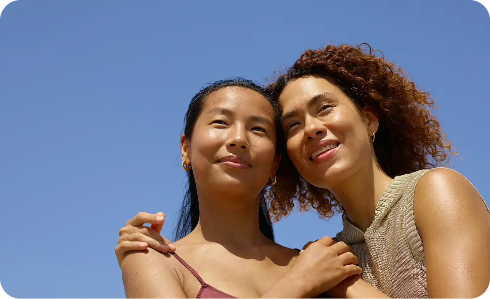 there are two women that are standing together in the sky