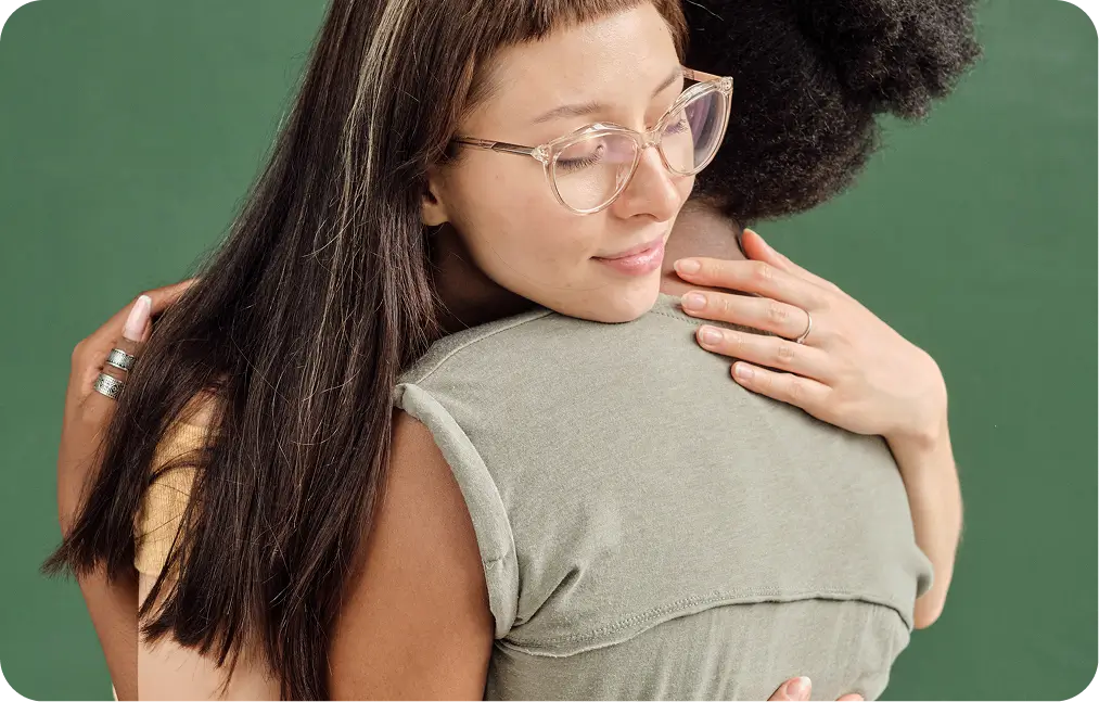 there is a woman hugging a man with a green background