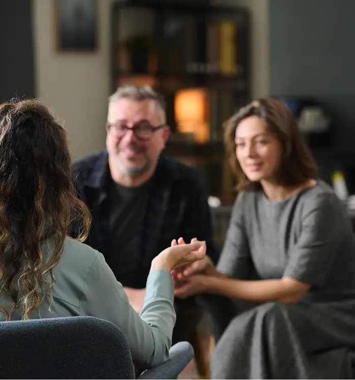 there are three people sitting in a room talking to each other