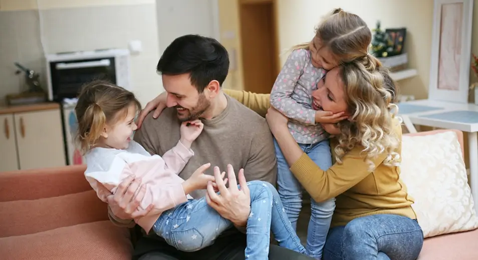 araffe family sitting on a couch in a living room