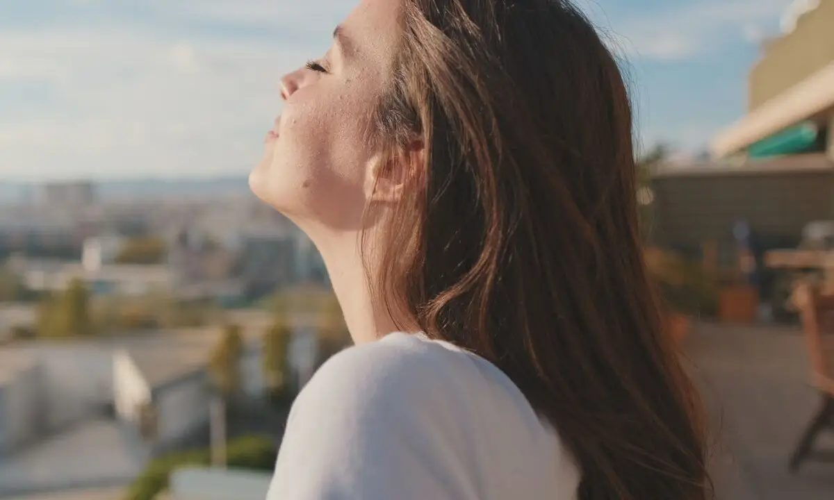 a close up of a woman looking up at the sky