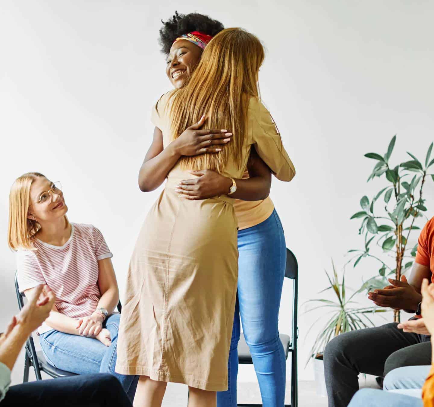 Women comforting each other in a group setting during depression treatment in Massachusetts.