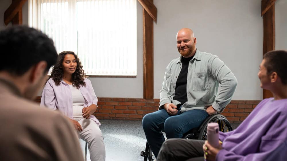 Support group meeting representing the choice between PHP and IOP at Rebuilding Recovery Centers.