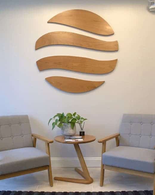 Modern waiting area with wooden wall logo for Rebuilding Recovery Center, who offer a Veterans & First Responders Rehab in MA