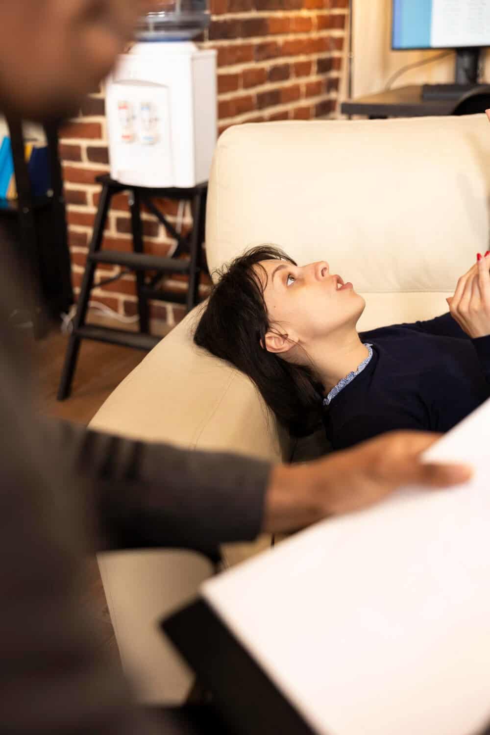 Woman lying on a therapy couch during an outpatient anxiety treatment session at Rebuilding Recovery Center in Massachusetts.