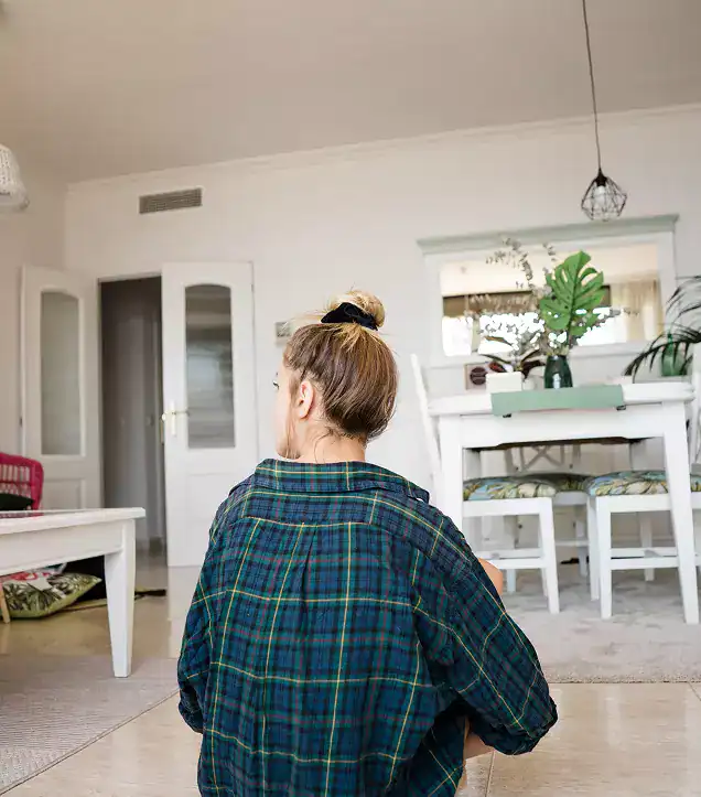 Woman sitting at home in quiet reflection before beginning meth addiction treatment in MA at Rebuilding Recovery Center.
