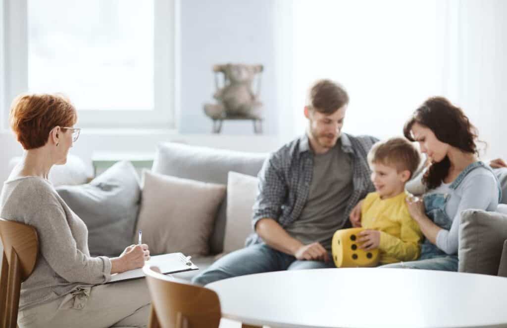 Therapist helping family members communicate during family therapy in Massachusetts.