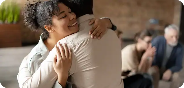 Man and woman embracing during a group therapy session at marijuana rehab in Easton, MA with Rebuilding Recovery Center.