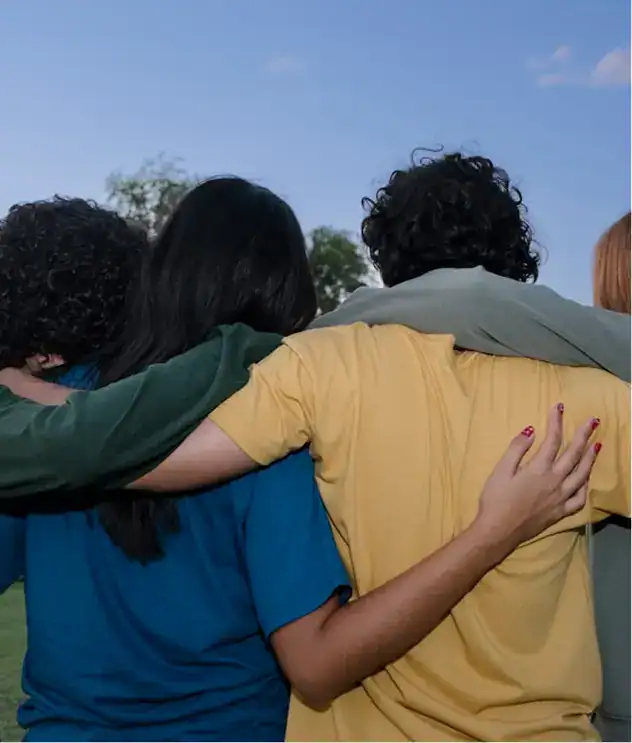 several people are hugging each other in a circle
