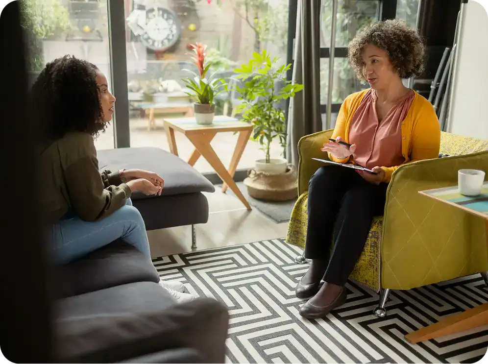 Therapist taking notes while talking with a patient during meth addiction treatment in MA at Rebuilding Recovery Center.