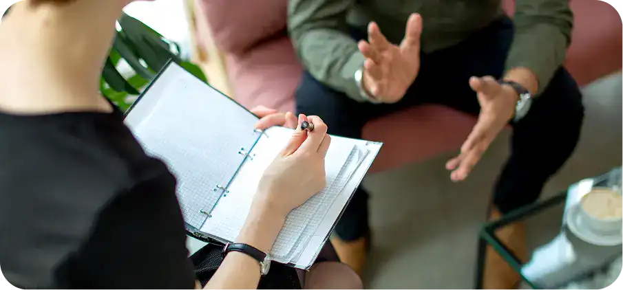 Man gesturing while speaking with a therapist during Xanax addiction treatment in Easton, MA at Rebuilding Recovery Center.