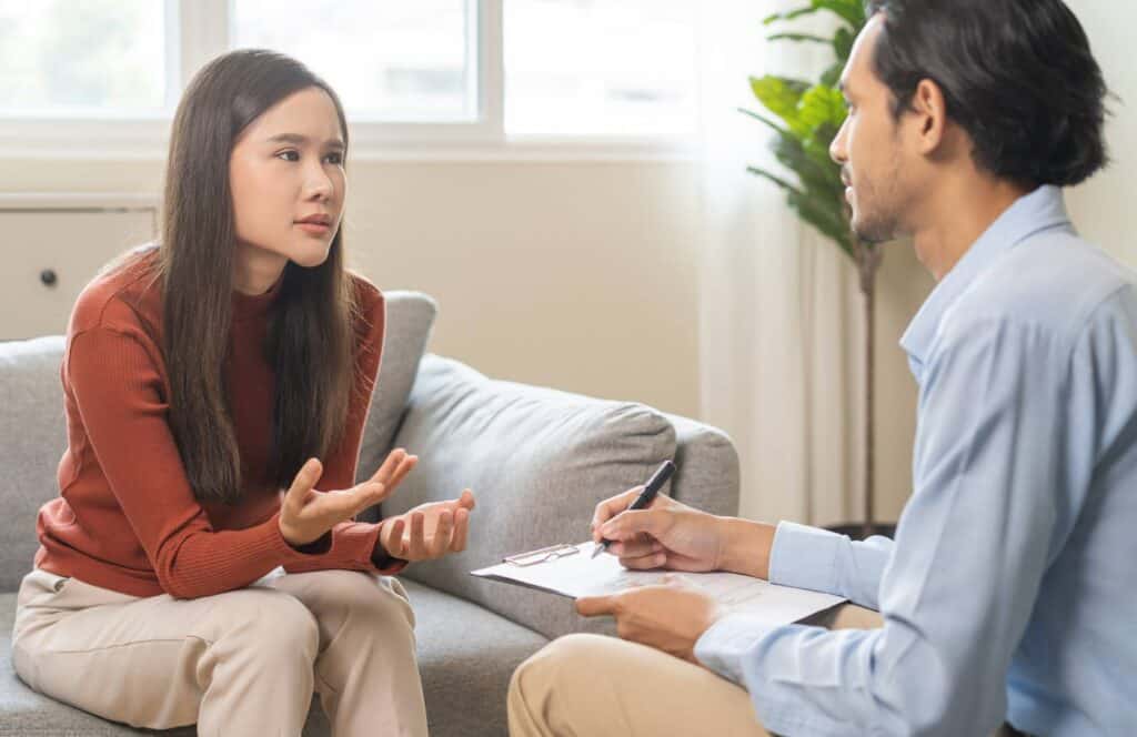 Woman having a private conversation with a therapist during trauma counseling in MA.