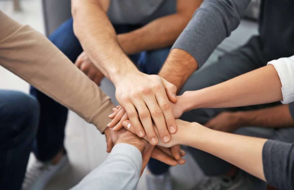 People sharing support and encouragement through holistic therapies in MA.