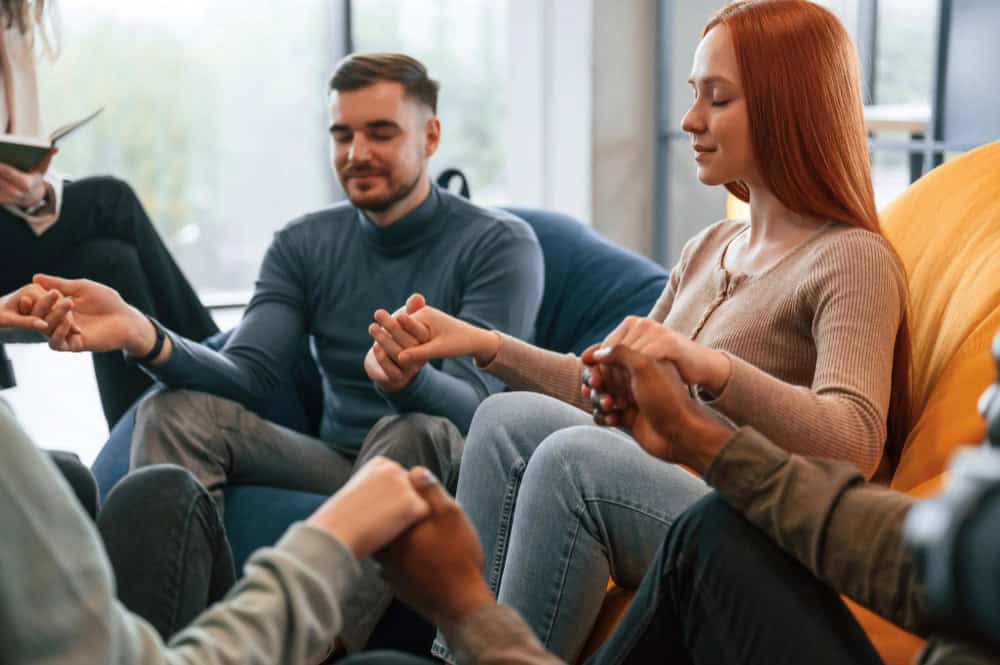 Group of people participating in a therapy session at Rebuilding Recovery Center in Easton, MA.