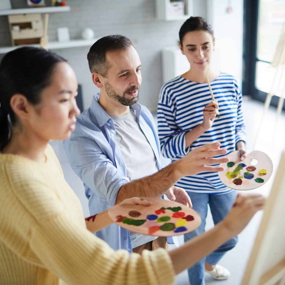People working together during expressive arts therapy for addiction in MA.