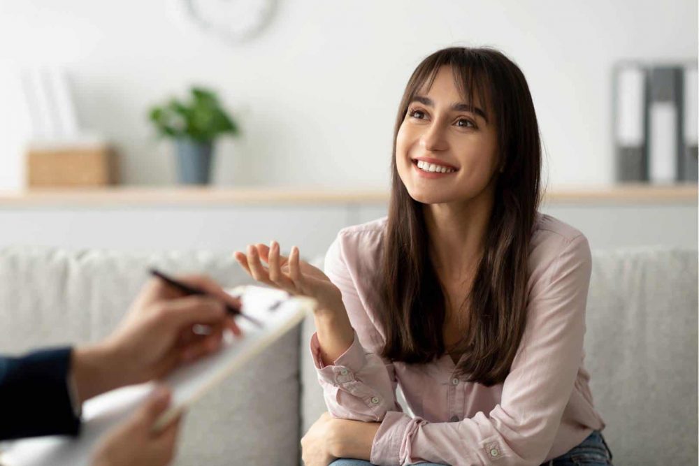 Narrative therapy for substance abuse in Easton, MA Woman speaking with a therapist during narrative therapy for substance abuse in Easton, MA.