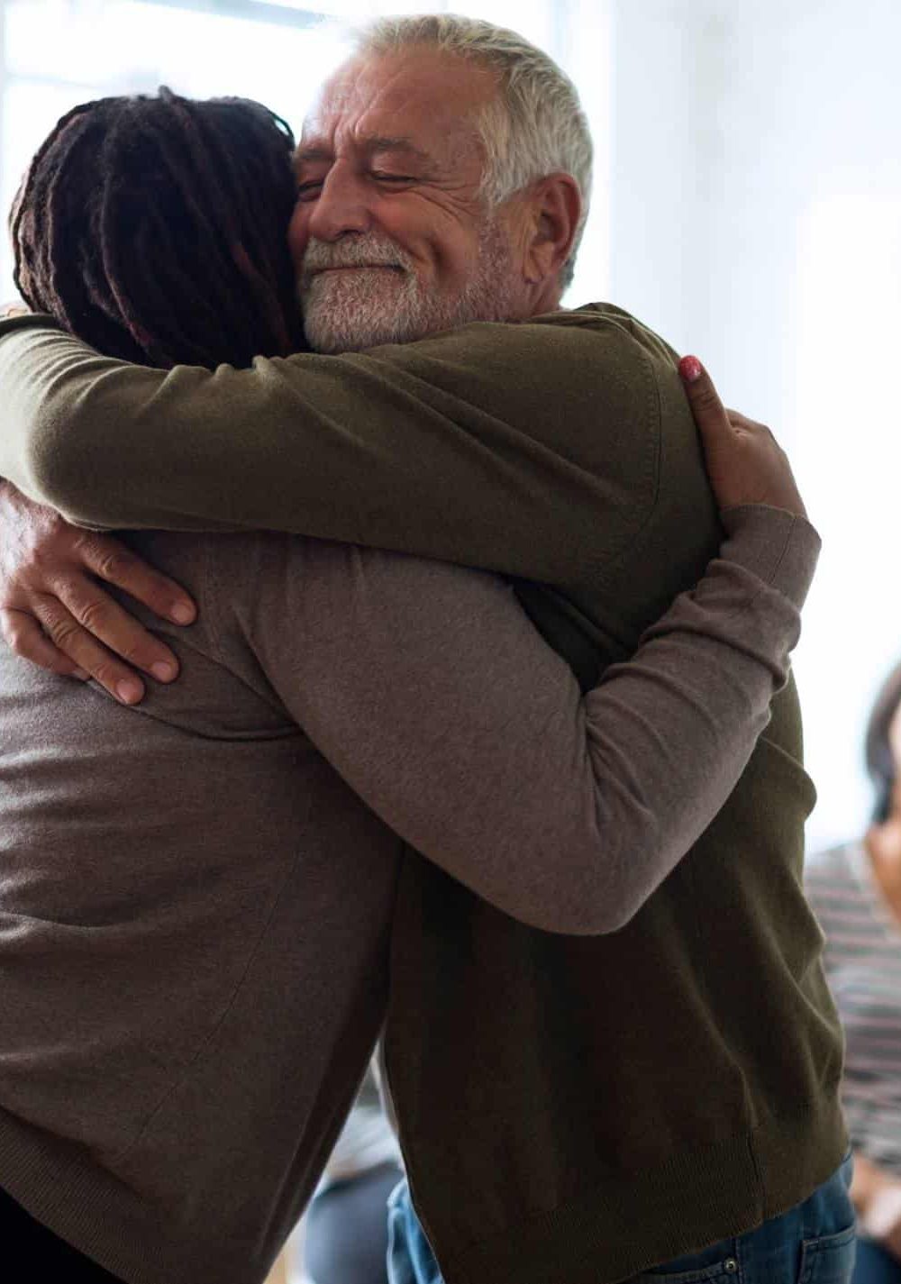 Man and woman embracing as they celebrate progress during fentanyl addiction treatment in Massachusetts at Rebuilding Recovery Center.